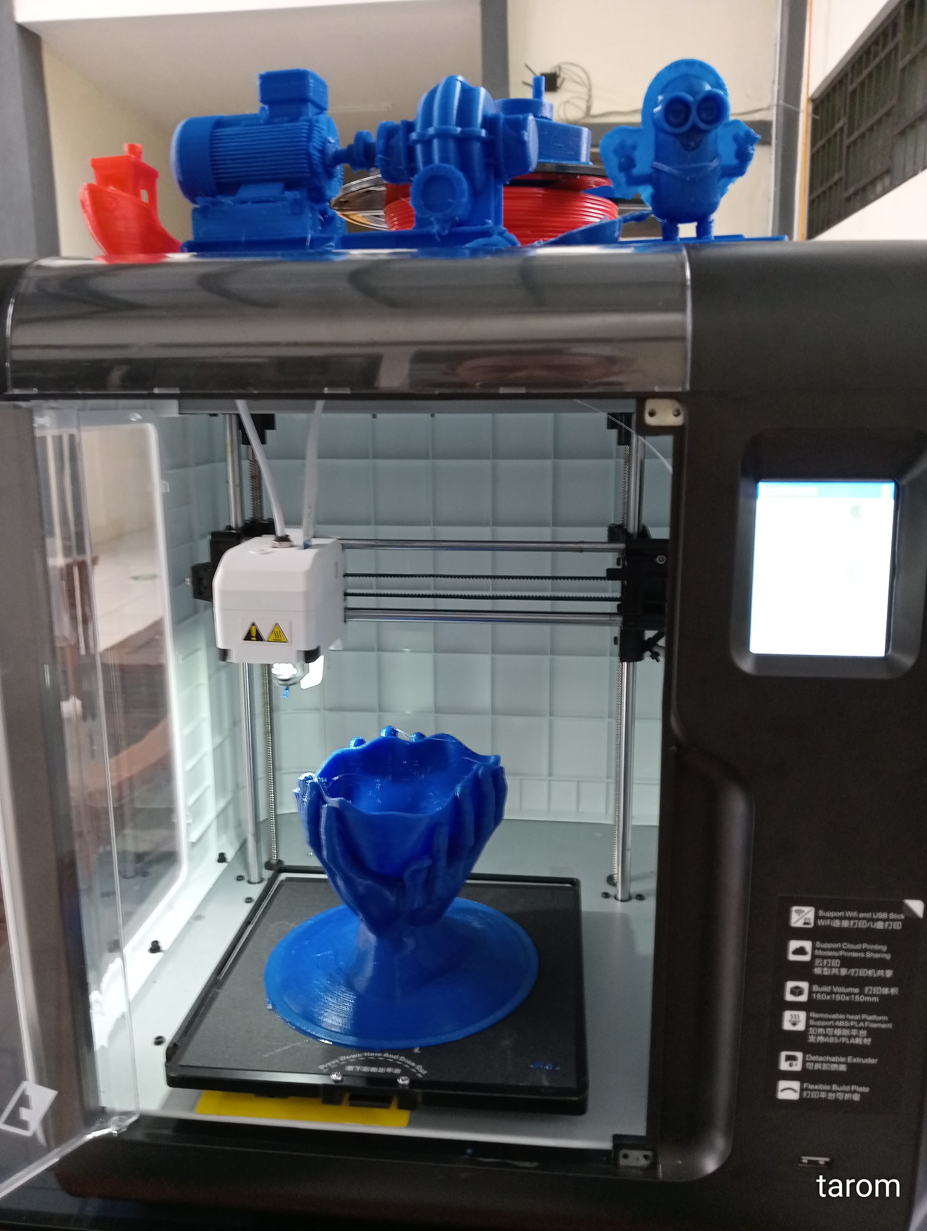A 3D printer with a partially printed object on the build plate