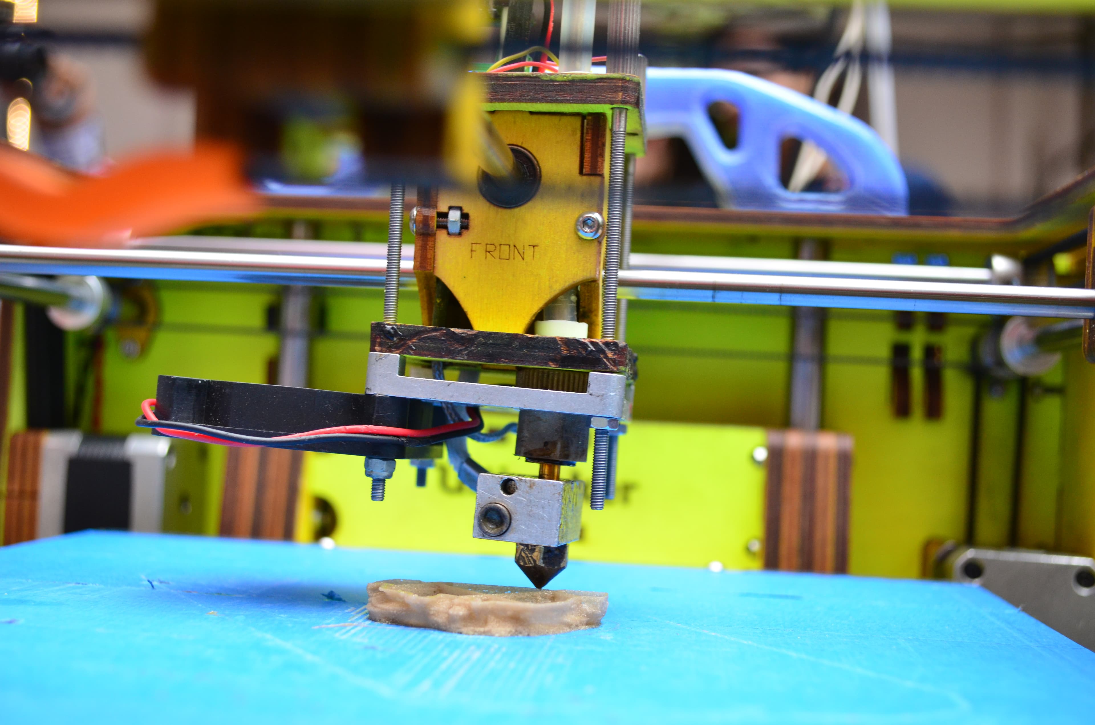 A 3D printer mid-print at a maker community event